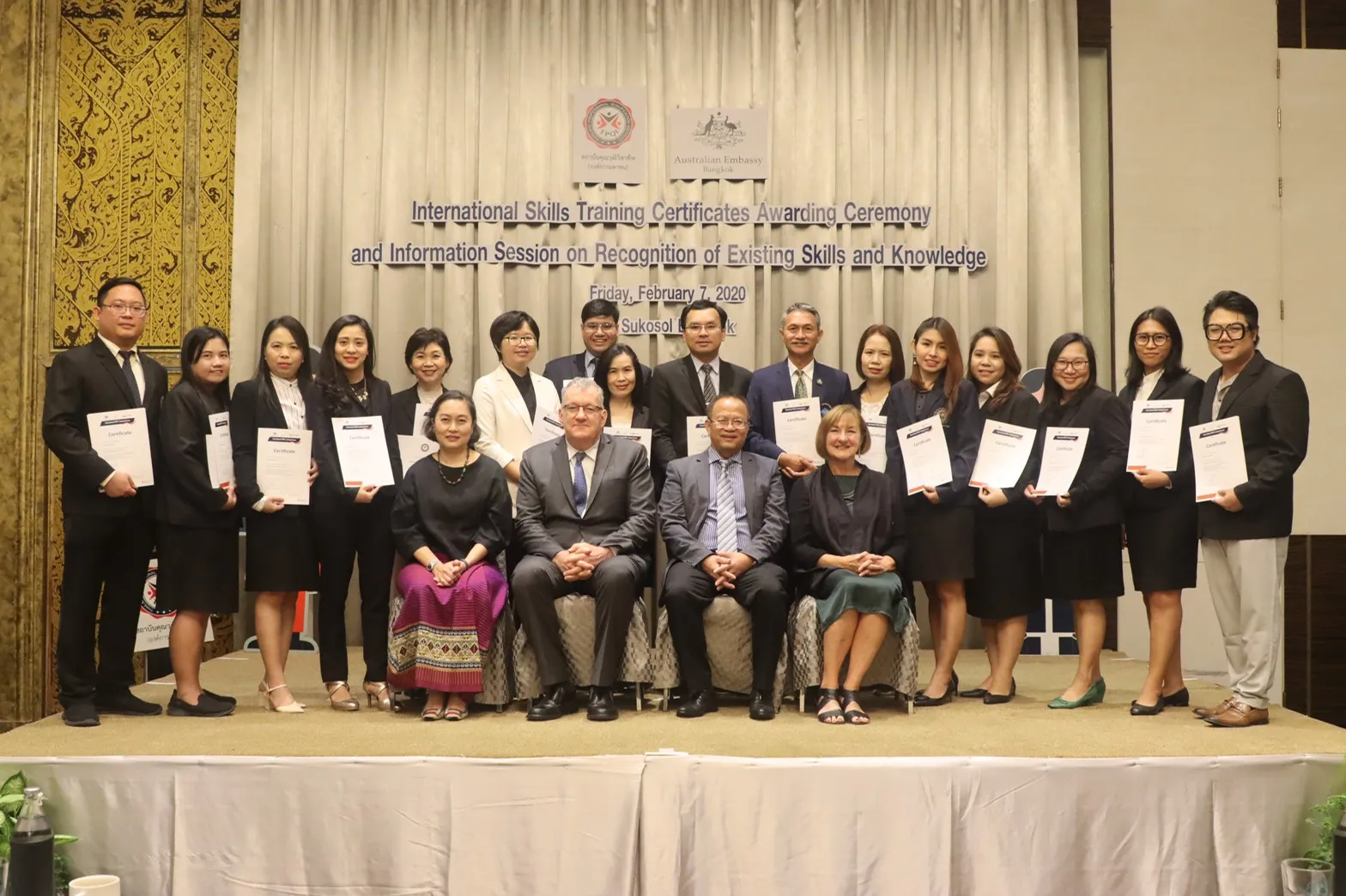 Group photo with certificates at an awards ceremony